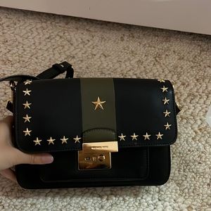 A super cute michael lots bag but missing one of the button but still functions